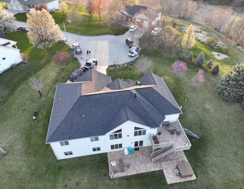 Aerial view of home with large driveway. 