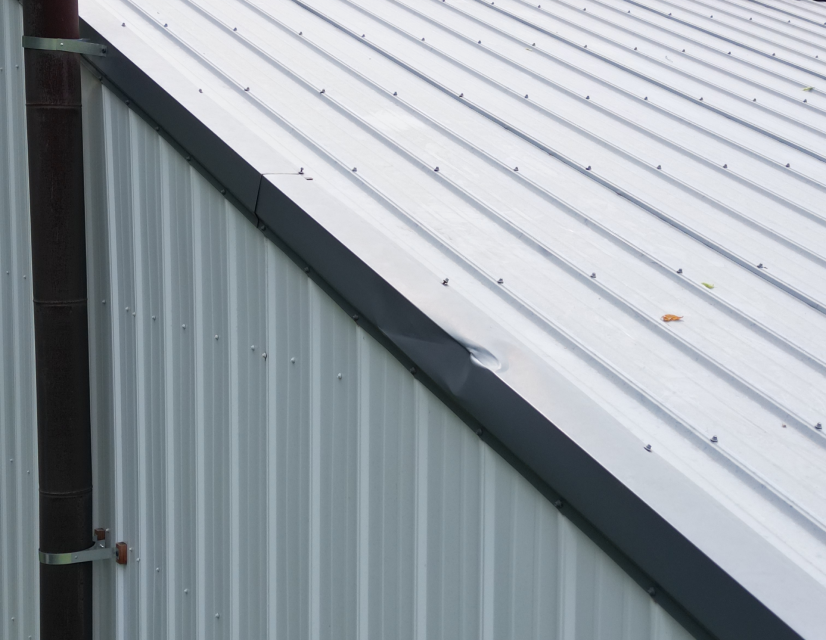 Dented metal roof.