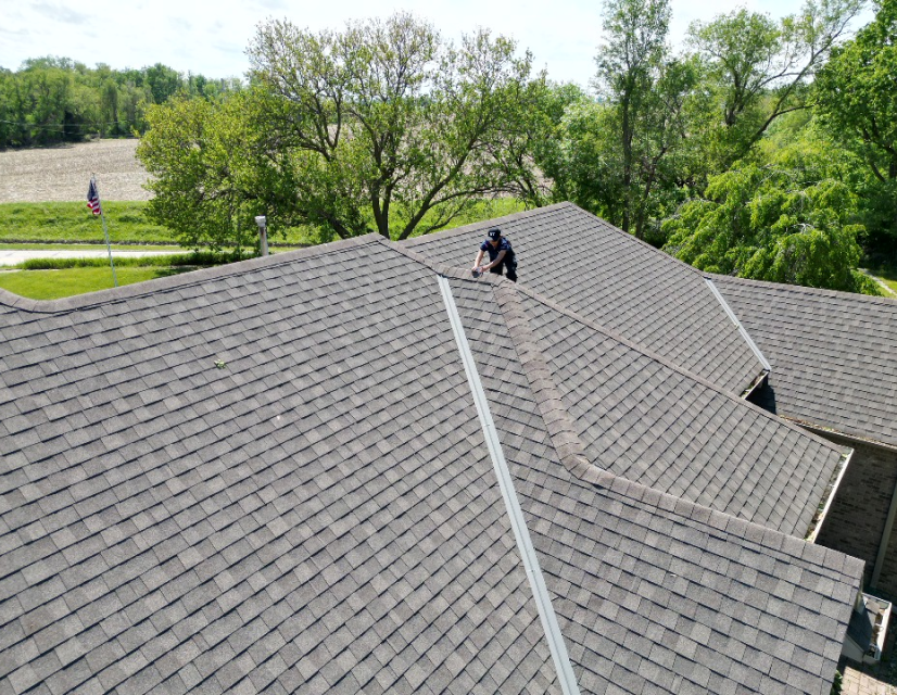 Man installing ridge of roof. 